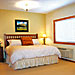 Glacier Ridge Suites - Affordable Luxury - Spacious suites feature down comforters on luxurious king beds & gourmet kitchens. The Glacier artwork, leather furniture, warm wood, tile & granite have guests saying 'WOW'!